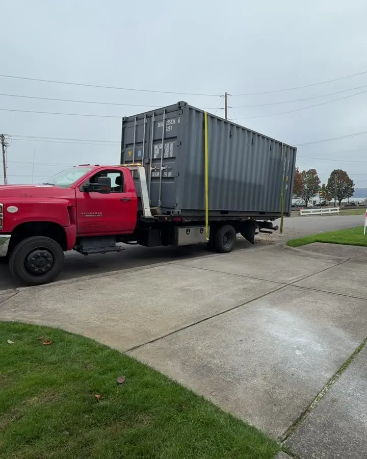 20 foot shipping container level and strapped down on the truck bed